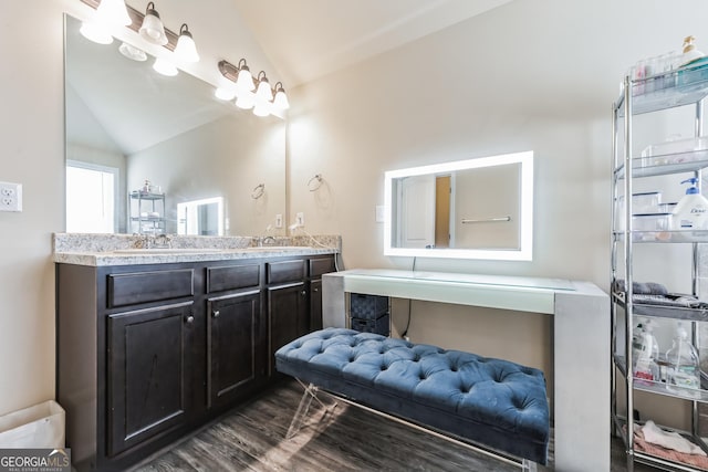 bathroom featuring lofted ceiling, wood-type flooring, and vanity