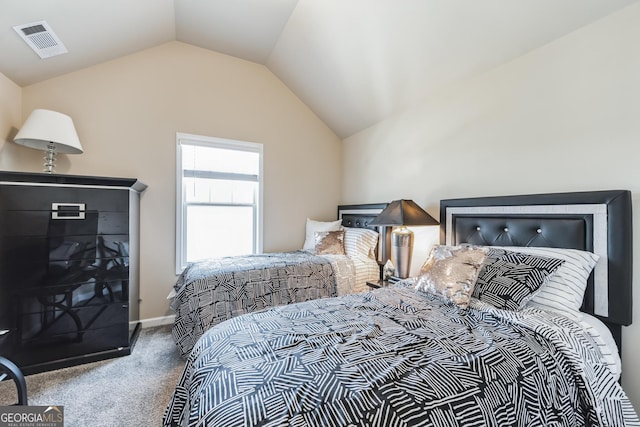 bedroom featuring vaulted ceiling and carpet