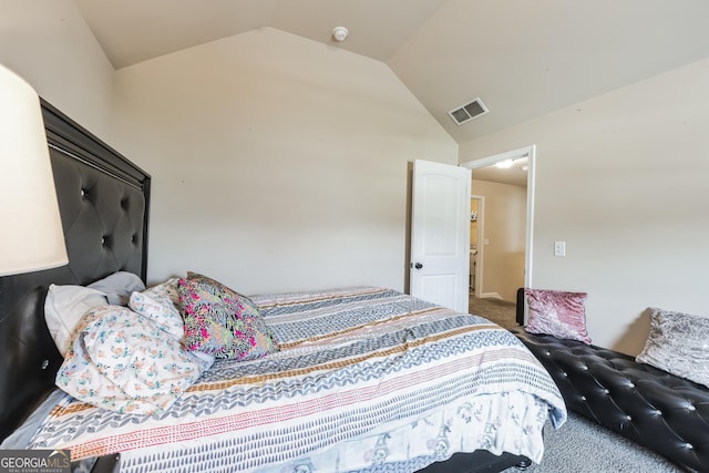 carpeted bedroom featuring vaulted ceiling