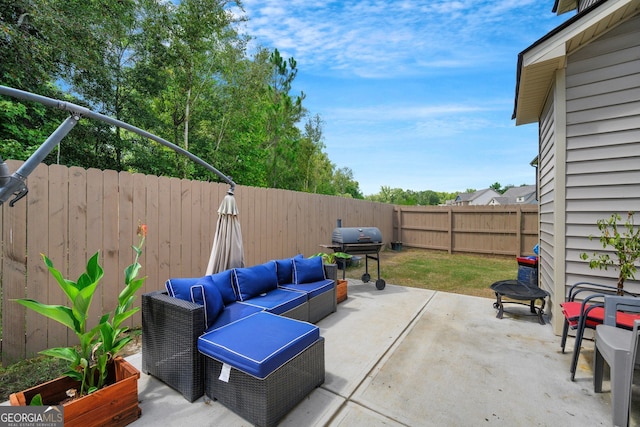 view of patio / terrace with grilling area and an outdoor living space with a fire pit