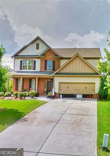 view of front of house featuring a garage and a front yard