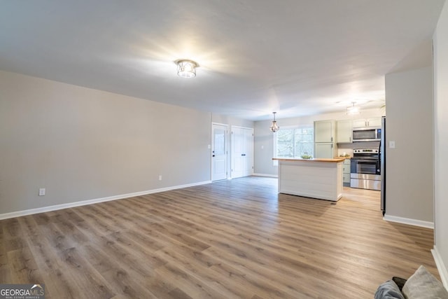 unfurnished living room with light wood-type flooring