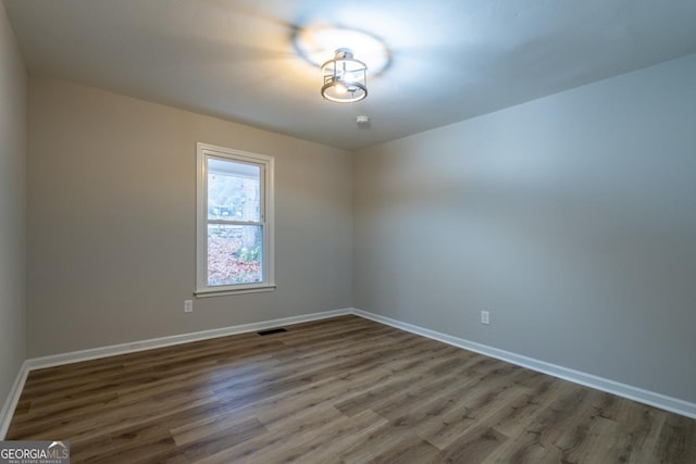 unfurnished room featuring wood-type flooring