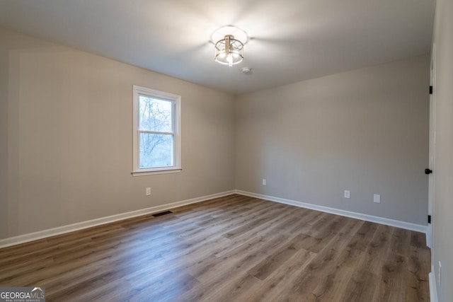 unfurnished room featuring hardwood / wood-style floors