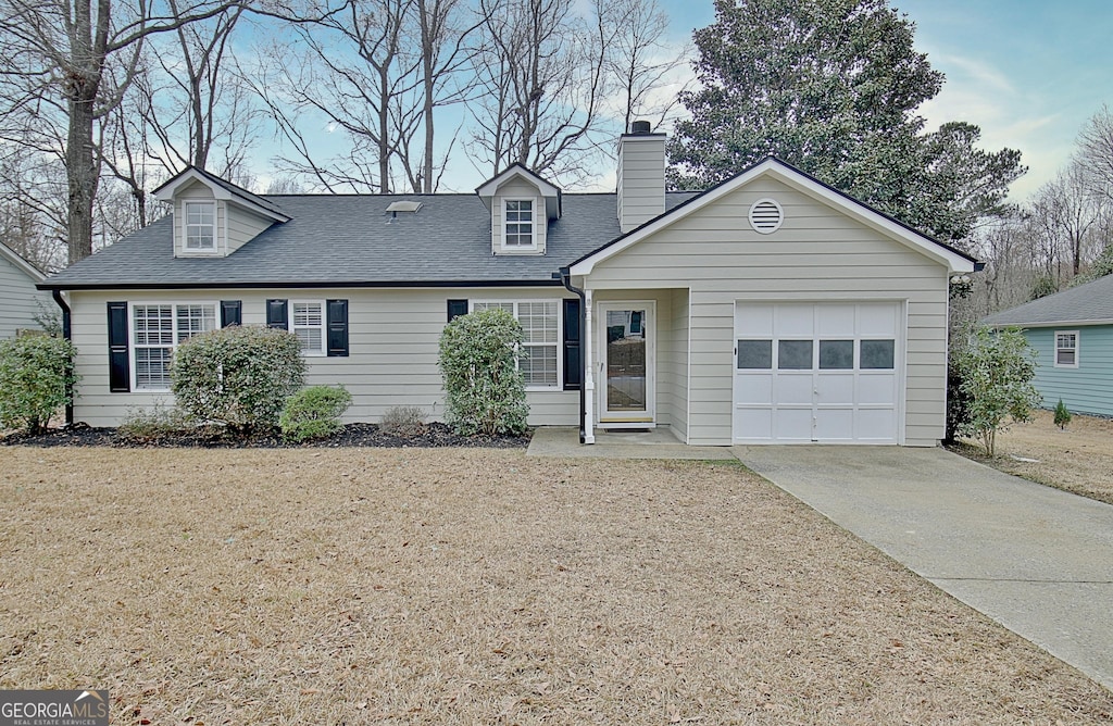 view of front facade with a garage and a front lawn