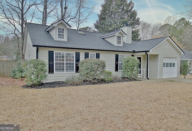 new england style home featuring a garage and a front lawn