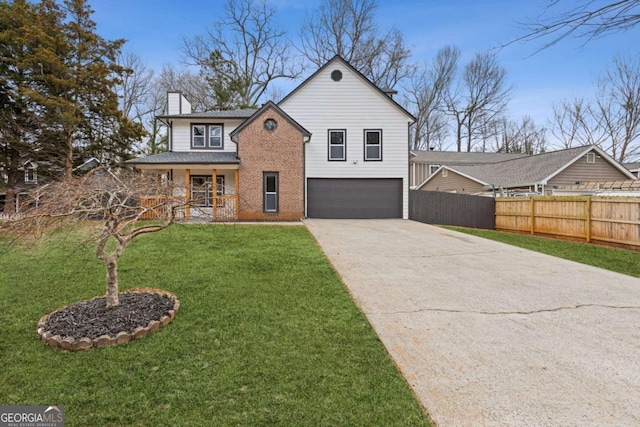 view of front of house with a garage, a front yard, and covered porch