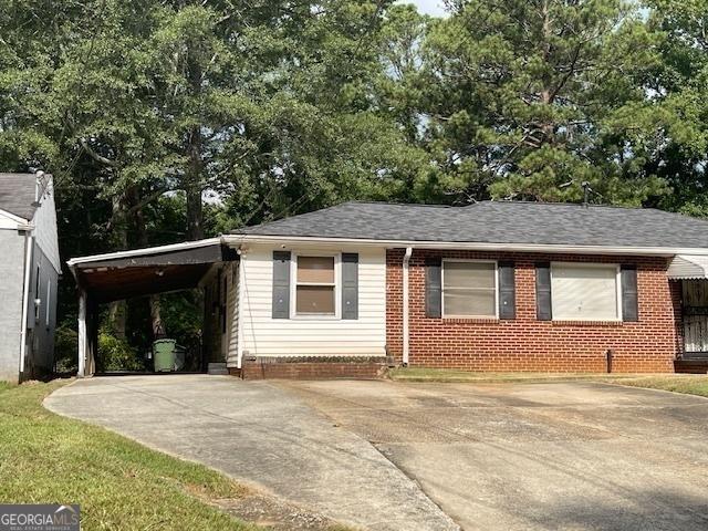 ranch-style home featuring a carport