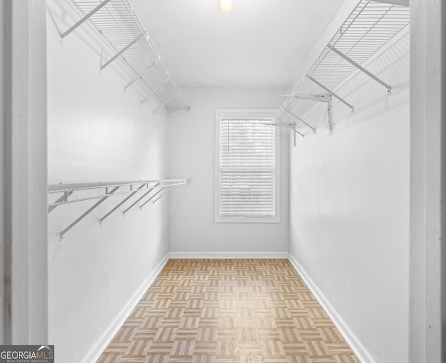 walk in closet featuring light parquet floors