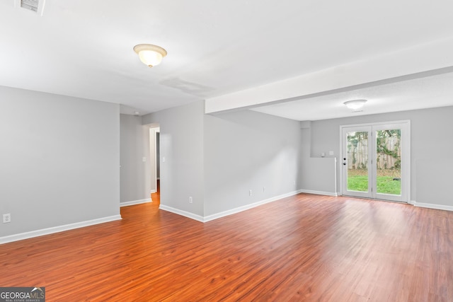 spare room with wood-type flooring