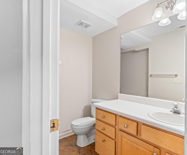 bathroom featuring vanity and toilet