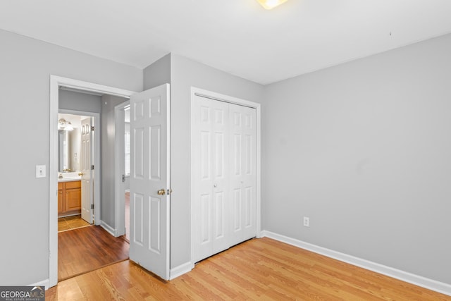 unfurnished bedroom featuring hardwood / wood-style floors and a closet