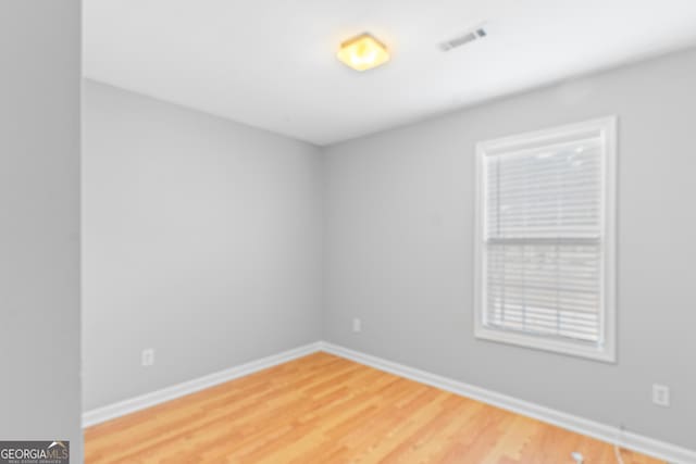 unfurnished room with hardwood / wood-style floors