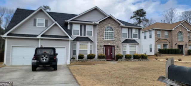 view of front of house with concrete driveway and an attached garage