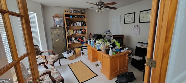 home office with light carpet and ceiling fan