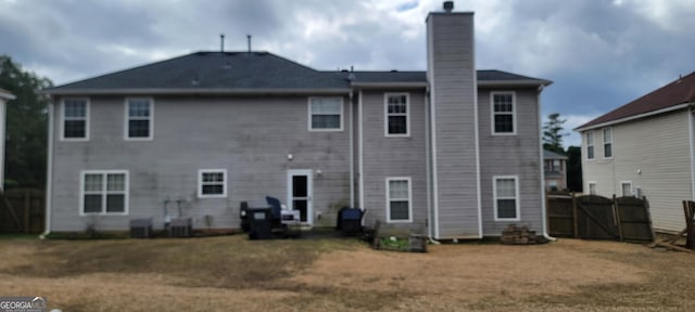 back of house featuring a lawn