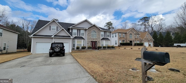 view of front of home featuring a garage and a front lawn