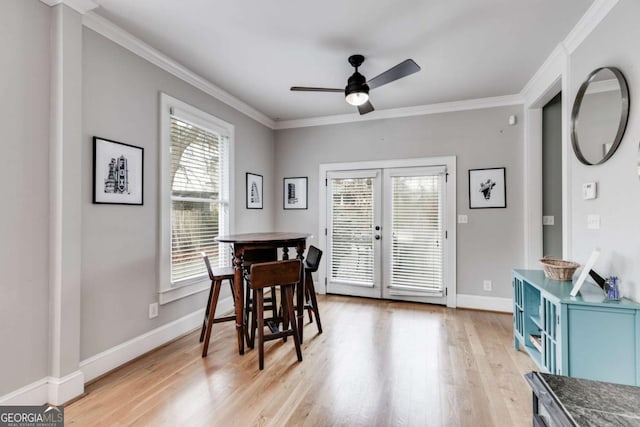 dining area featuring ornamental molding, ceiling fan, light hardwood / wood-style floors, and french doors