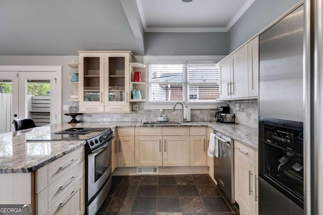 kitchen with sink, light stone counters, ornamental molding, appliances with stainless steel finishes, and backsplash