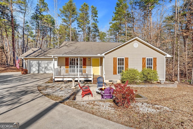 single story home with a porch and a garage