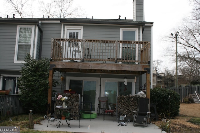 rear view of property with a balcony and a patio area