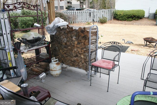 view of patio / terrace featuring a wooden deck and a fire pit