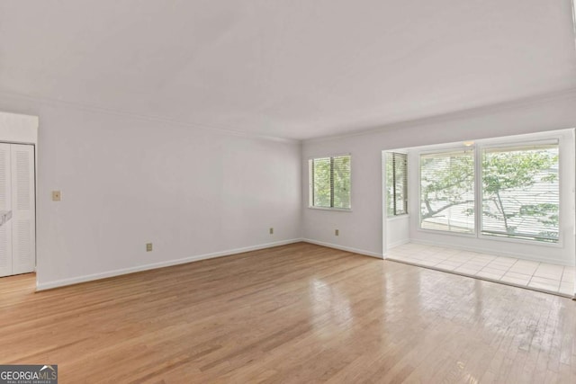 unfurnished room with light wood-type flooring