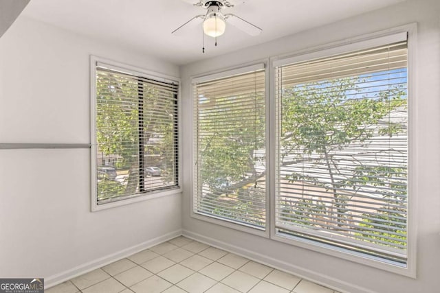 empty room with light tile patterned floors and ceiling fan