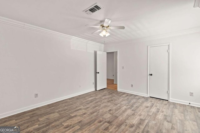 unfurnished room with ornamental molding, ceiling fan, and light wood-type flooring