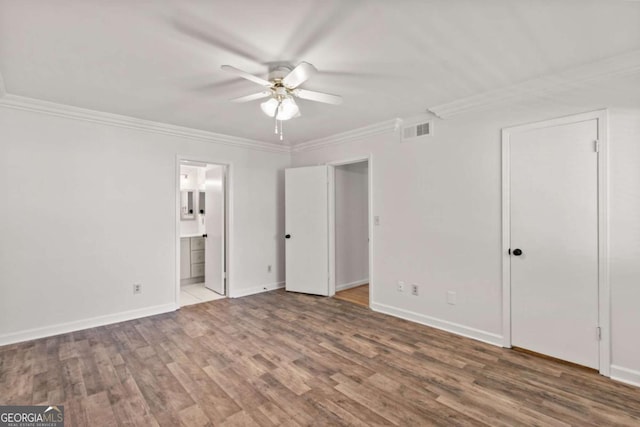 unfurnished bedroom featuring wood-type flooring, ornamental molding, ceiling fan, and ensuite bathroom