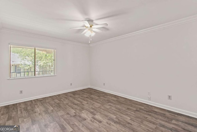 spare room with dark wood-type flooring, ceiling fan, and ornamental molding