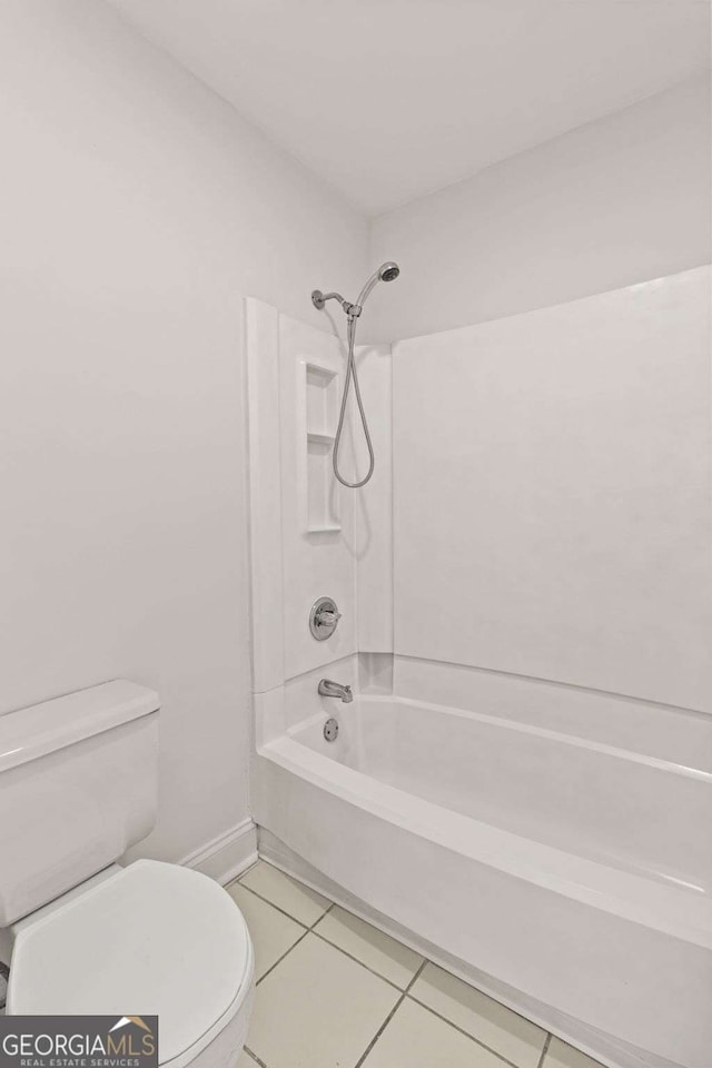 bathroom featuring shower / bath combination, tile patterned flooring, and toilet