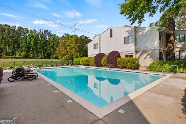 view of swimming pool featuring a patio area