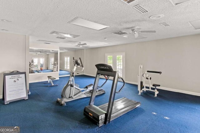 exercise room with a textured ceiling and ceiling fan