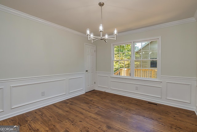 unfurnished dining area featuring crown molding, dark hardwood / wood-style floors, and a notable chandelier