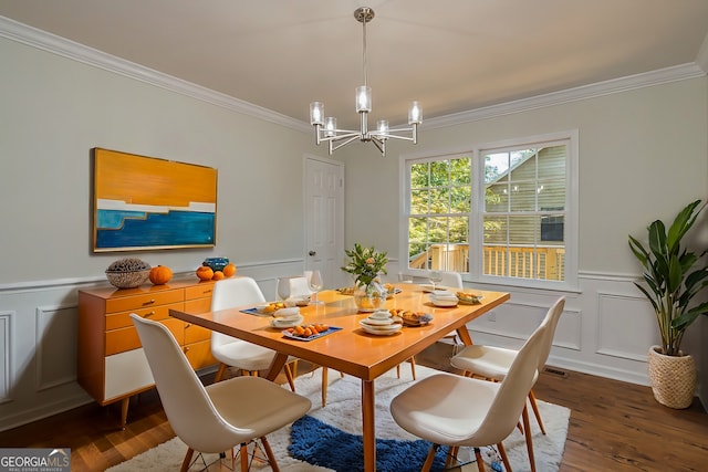 dining area with ornamental molding, wood-type flooring, and a notable chandelier