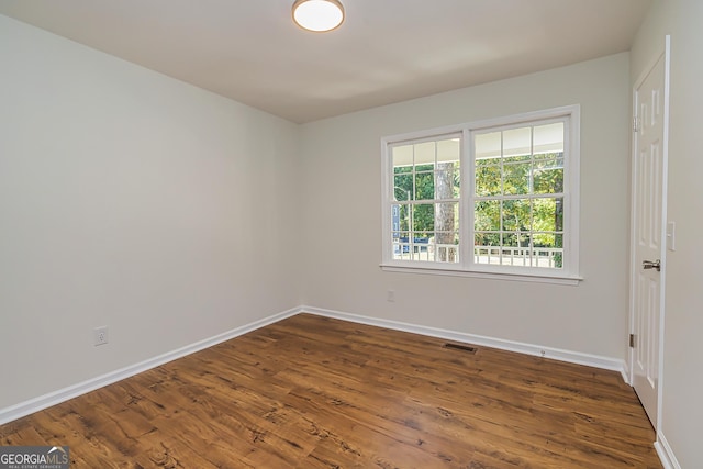 spare room featuring dark hardwood / wood-style floors