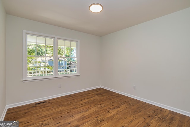 empty room featuring dark hardwood / wood-style flooring