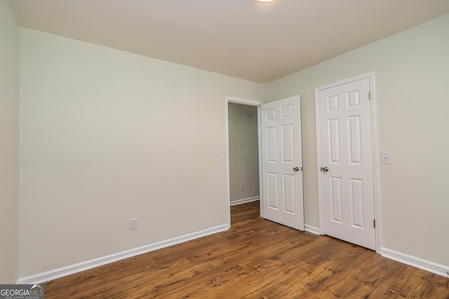 unfurnished bedroom featuring dark hardwood / wood-style flooring