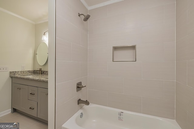 bathroom featuring vanity, tile patterned flooring, ornamental molding, and tiled shower / bath