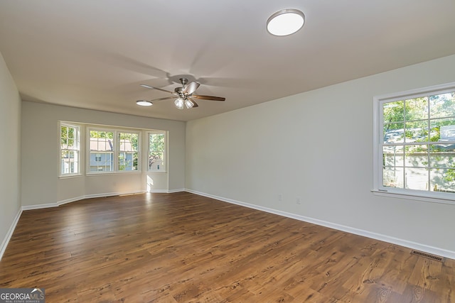 unfurnished room featuring dark hardwood / wood-style flooring and ceiling fan