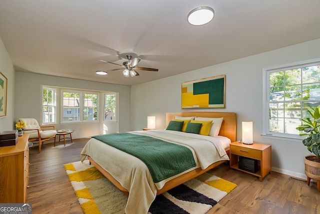 bedroom with wood-type flooring and ceiling fan