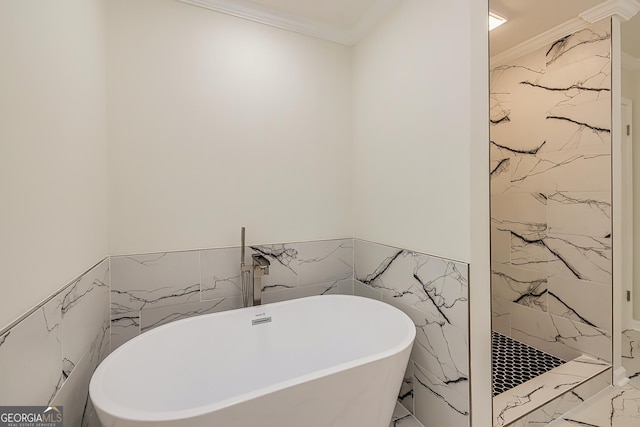 bathroom featuring ornamental molding and separate shower and tub