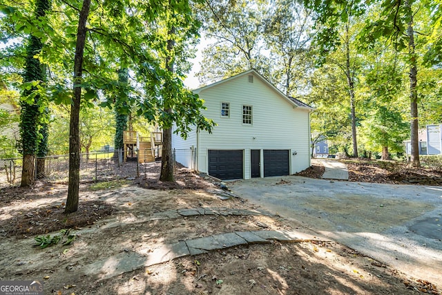 back of house featuring a garage