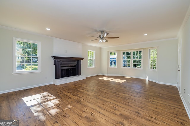 unfurnished living room with dark wood-type flooring, ornamental molding, and ceiling fan