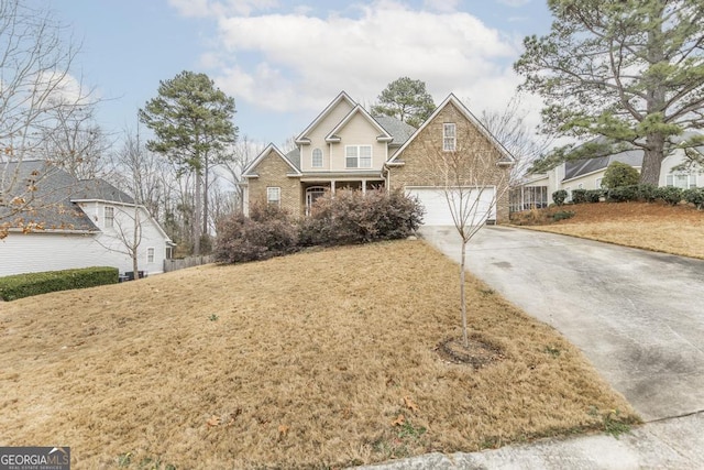 view of front facade featuring a garage, a porch, and a front lawn