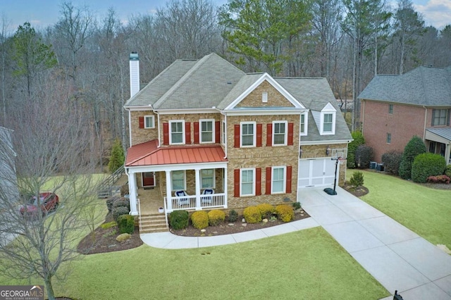 view of front facade with a garage, a front lawn, and a porch