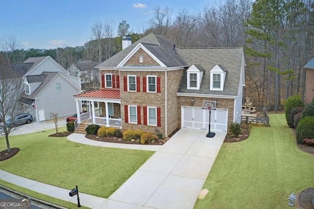 view of front facade with a garage, a front lawn, and covered porch