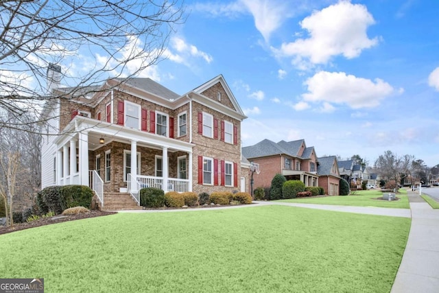 view of front of home featuring a front yard and covered porch