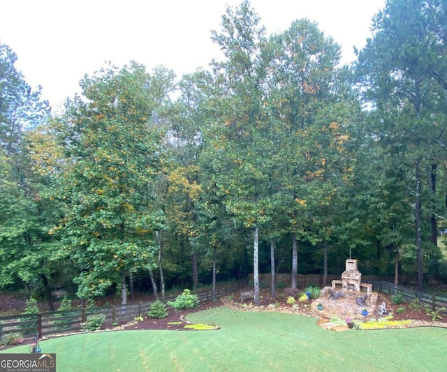 view of yard with an outdoor fireplace